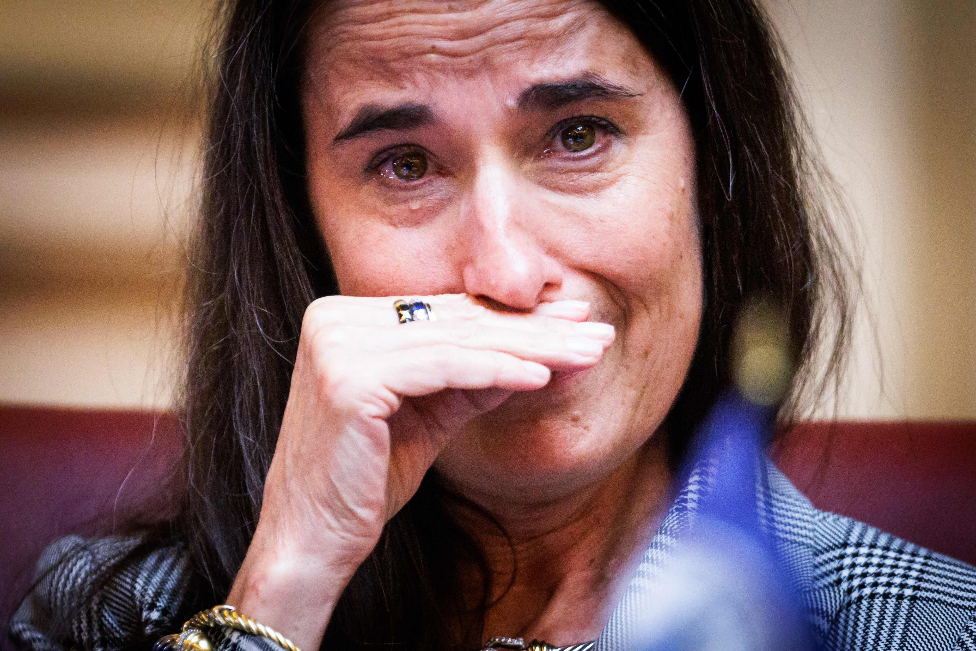 State Sen. Jennifer Boysko (D–Fairfax) wipes away tears as state Sen. Tammy Brankley Mulchi (R–Mecklenburg) talks about her personal experience with domestic violence following a special session of the Virginia General Assembly on Friday, October 31, 2025 at the Capitol in Richmond.