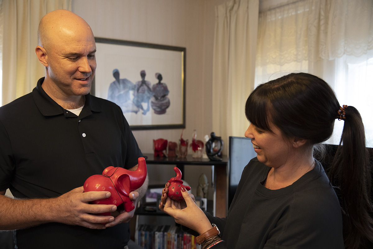 Mike Kelleher and Jamie Ebanks look through Haynes' collection of red elephants, symbolizing her sorority&nbsp;???.