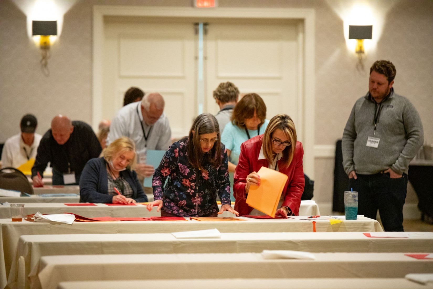 Glenn Youngkin’s Pitch: Tighter Voting Laws, Broader GOP Tent, and Money to Make it Happen 1 Republican volunteers count ballots at a hotel ballroom in downtown Richmond. (Crixell Matthews/VPM News)