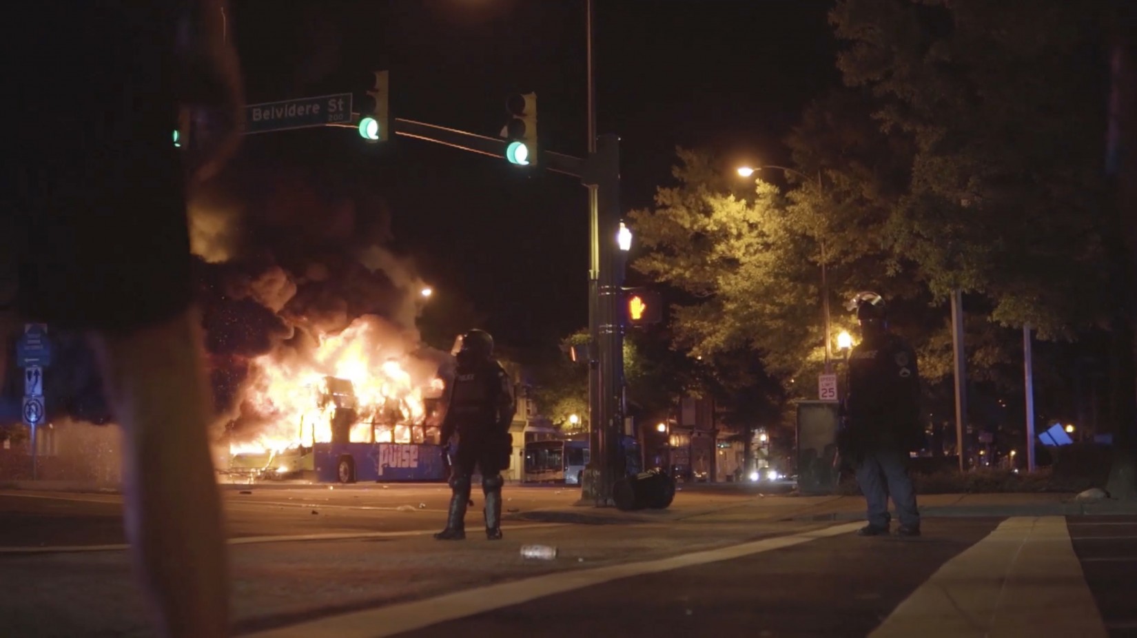 “Why This Moment” captures Richmond’s frustrations over police brutality. Watch the film Thursday, Sept. 30 on VPM PBS 2 Police officers watch as a Greater Richmond Transit Company bus burns down and protestors retreat from the fire. (Photo provided by VPM)