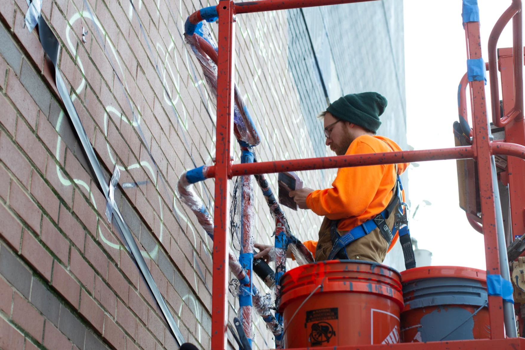 Westergard completes Harrisonburg chessman mural 1 Nils Westergard sketches in the chess board from a boom lift in downtown Harrisonburg.