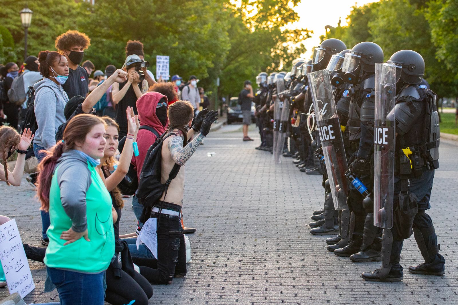 'It’s Meant To Be Punishing': Protestors Allege Summer of Jail Abuses 2 Protestors kneel before a line of police on June 1. (Photo: Crixell Matthews/VPM News)
